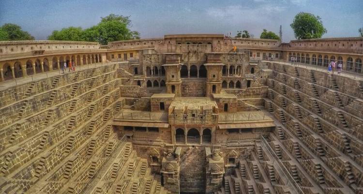 Wide-angle view of a massive stepwell showing its intricate architecture