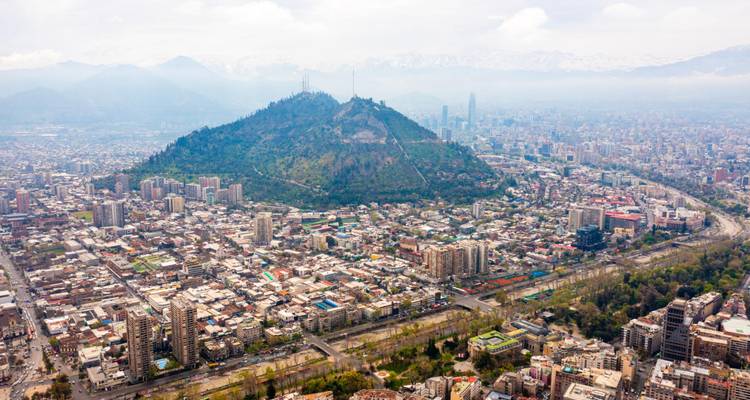 Another elevated panorama of Santiago with San Cristóbal Hill and distant snow-dusted peaks.