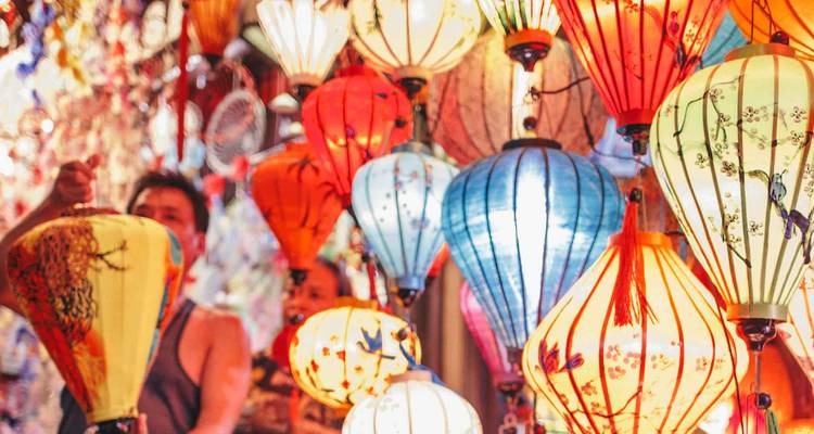 Vibrant silk lanterns in a night market create a kaleidoscope of color and light.
