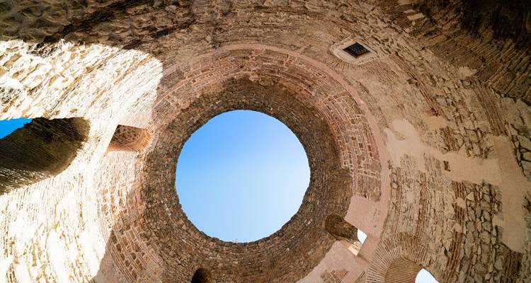 View up through the circular vestibule of Diocletian’s Palace revealing blue sky.