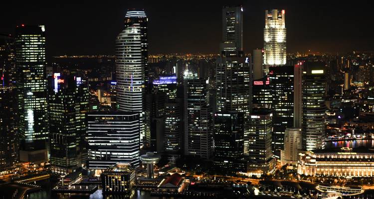 Dramatic night skyline of Singapore’s financial district filled with illuminated skyscrapers