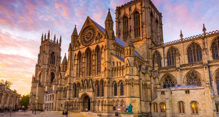York Minster’s gothic towers glow at sunset under a pastel sky.