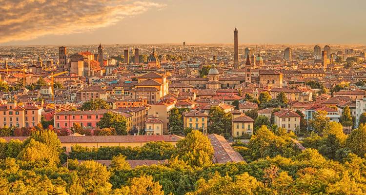 Golden sunset over Bologna’s historic skyline dotted with medieval towers and terracotta roofs