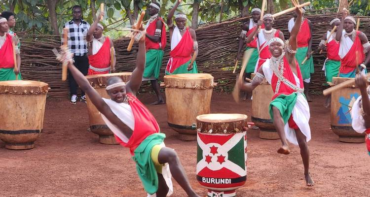 Joyful Burundian drummers leap as they beat decorative drums during a traditional show.