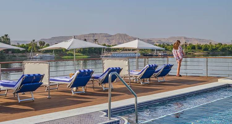 Cruise passenger looking across pool deck toward Nile river and distant mountains