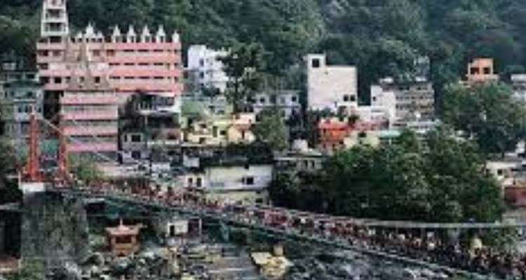 Pixelated distant view of buildings and busy suspension bridge crossing a Himalayan river.