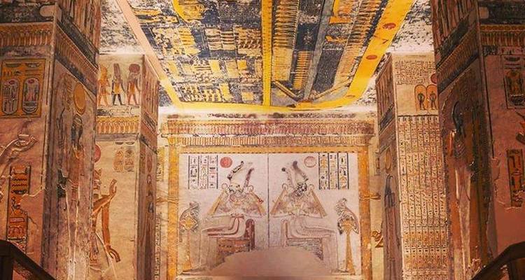 Detailed view of ornate wall and ceiling paintings inside an ancient Egyptian tomb chamber.