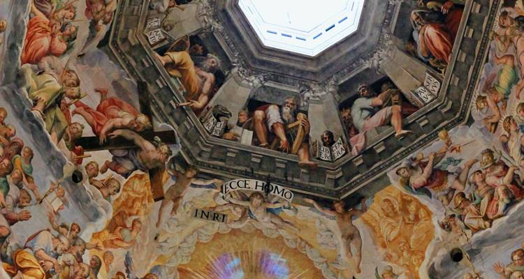 Vibrant Renaissance frescoes decorating the interior of a cathedral dome viewed upward toward the oculus.