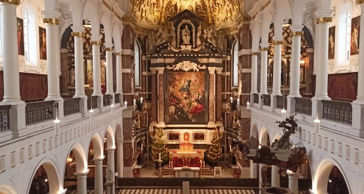 Lavish baroque church interior with gilded ceiling and grand altar.