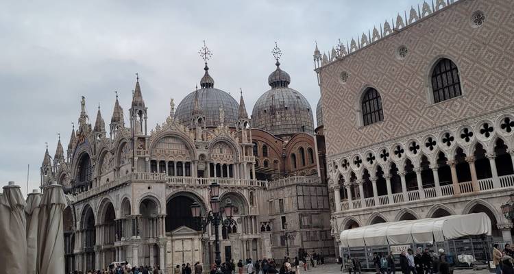 Grand vista of St Mark’s Basilica and Doge’s Palace busy with crowds in Venice.