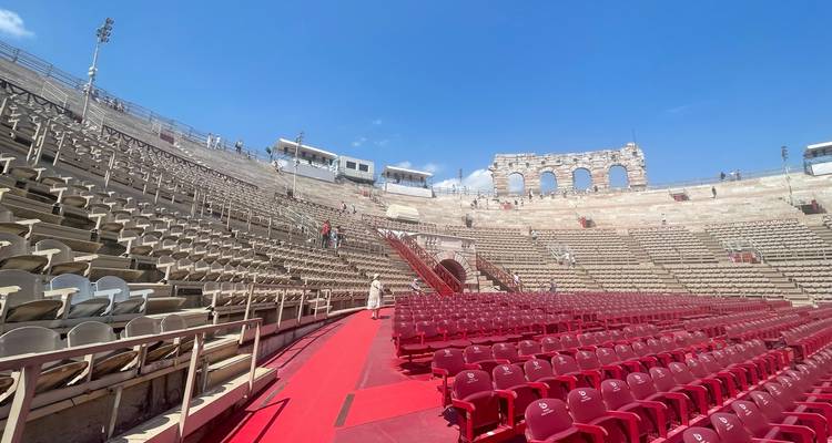 Interior of Verona Arena with rows of red chairs set for a performance.