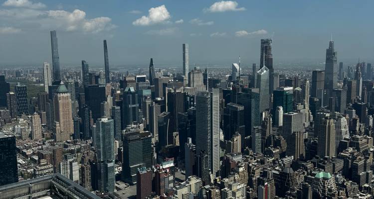 Sweeping bird’s-eye view of Midtown Manhattan’s dense forest of skyscrapers.
