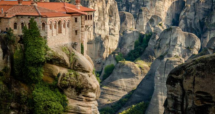 Monastery clings to towering rock pillars amid the dramatic landscape of Meteora