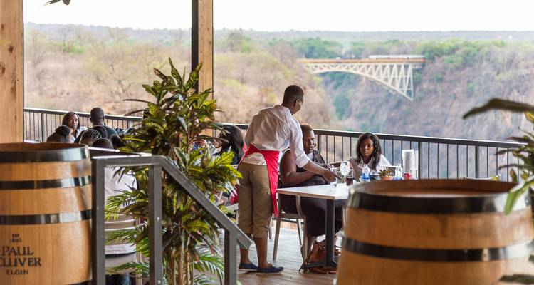 Outdoor restaurant overlooking gorge and historic Victoria Falls Bridge