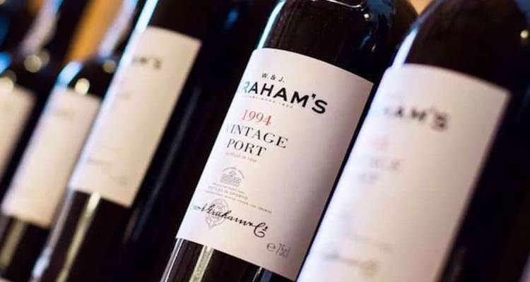 Row of vintage Port wine bottles with focus on a 1994 Graham's label.