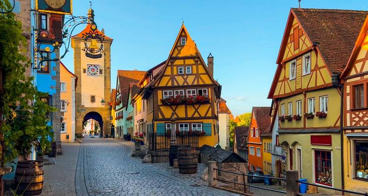 La luz matutina baña las casas de entramado de madera y la calle de adoquines de la intersección Plönlein de Rothenburg.