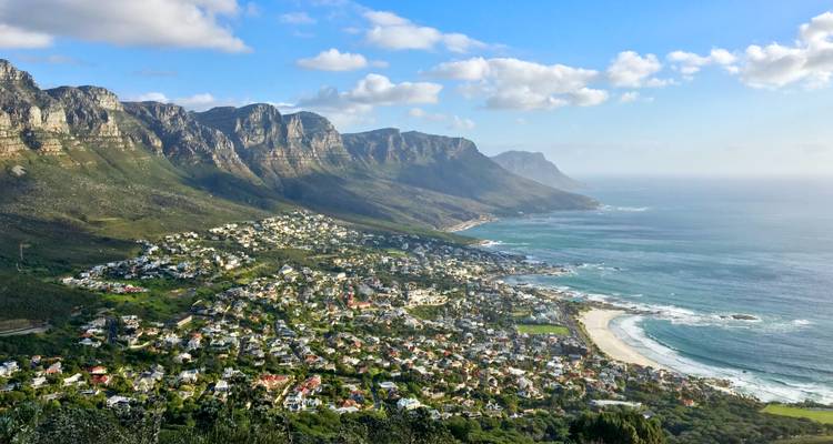 Aerial panorama of Cape Town’s coastal suburbs backed by the 12 Apostles mountain range and the Atlantic Ocean.