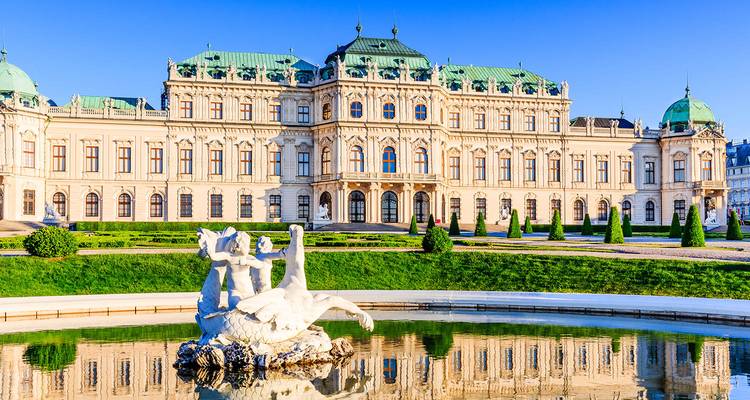 Sunny morning view of Vienna’s Belvedere Palace reflected in an ornamental pond.
