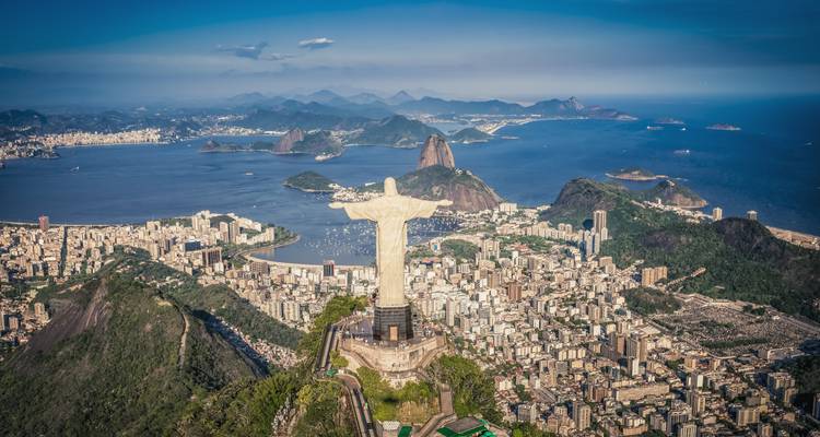 Aerial view of Christ the Redeemer statue overlooking Rio’s sprawling cityscape, bays and distant islands.