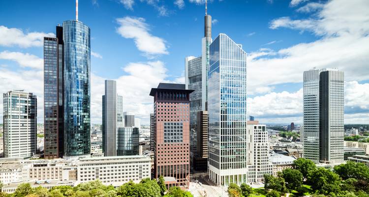 Bright summer view of Frankfurt's modern skyscrapers against a blue sky.
