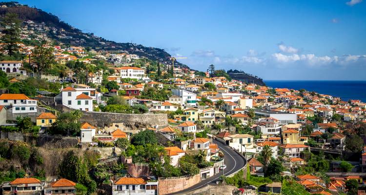 Terraced hillside city with orange rooftops overlooking the Atlantic on Madeira.