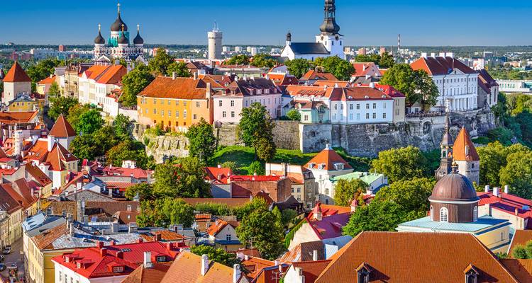 Historic skyline of a Baltic capital featuring red roofs and medieval towers