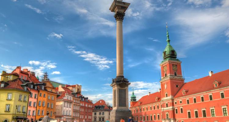 Sigismund's Column and colorful royal castle square under a bright sky