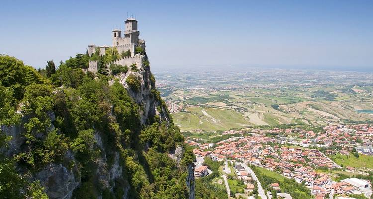 Medieval fortress perched on a dramatic cliff overlooking a panoramic countryside