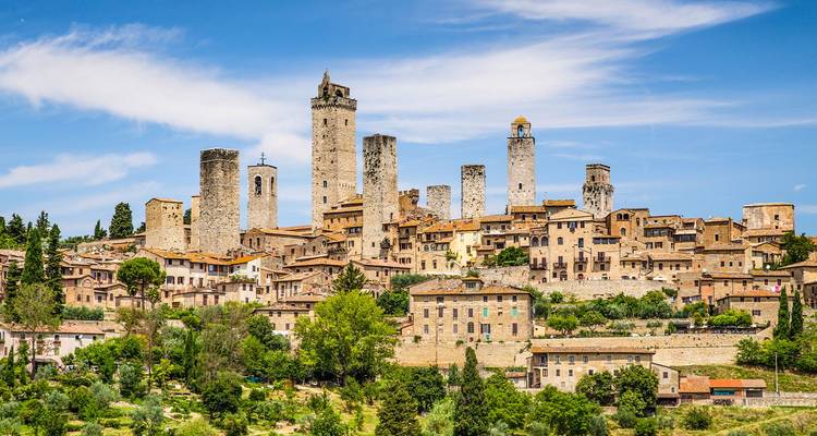 Medieval town of San Gimignano distinguished by numerous stone towers against a blue sky
