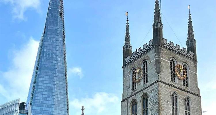 Contrasting skyline of The Shard beside historic Southwark Cathedral under blue sky.
