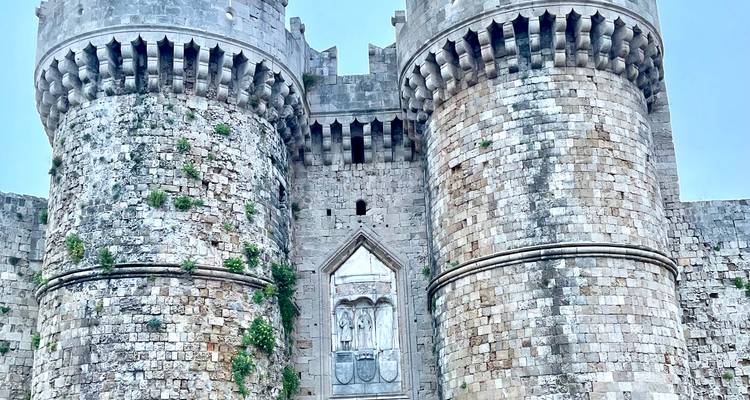 Close-up view of imposing medieval fortress towers built of rough stone blocks