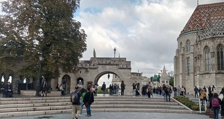 Crowds gather on the steps of Fisherman’s Bastion with Matthias Church roof visible to the right.