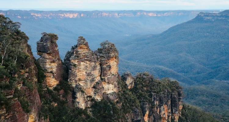 The Three Sisters rock formations overlooking the vast eucalyptus-filled valleys of the Blue Mountains.
