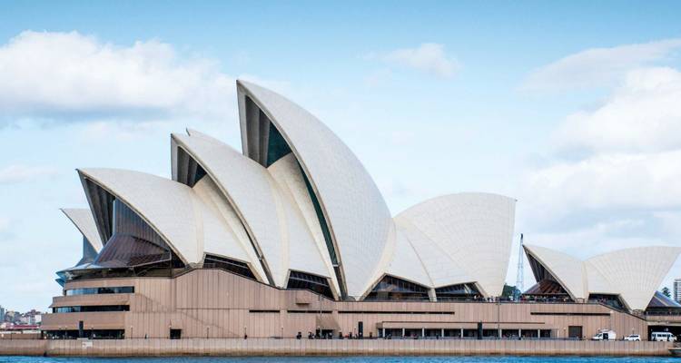 Iconic Sydney Opera House sails viewed across the harbor on a clear day