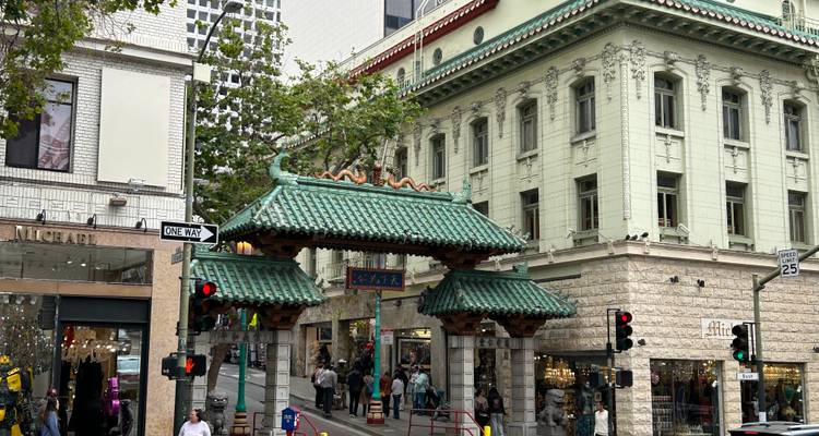 Dragon Gate entrance to Chinatown bustling with shoppers and traffic