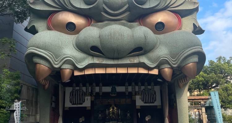 Close-up of the massive lion-head façade of Namba Yasaka Shrine with wide-eyed expression.