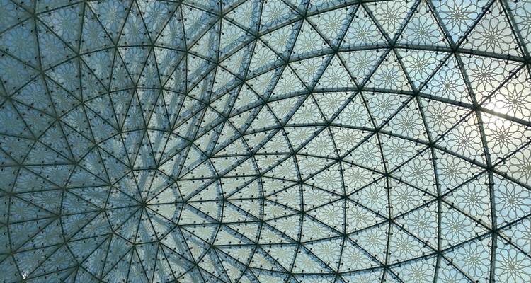 Intricate geometric glass ceiling pattern with morning light shining through