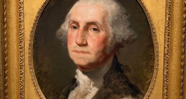 Portrait à l'huile classique de George Washington dans un cadre doré ovale exposé sur un mur de musée.