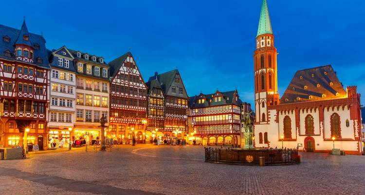 Timber-framed houses and the Old St Nicholas Church surrounding Frankfurt’s Römerberg square at blue hour.