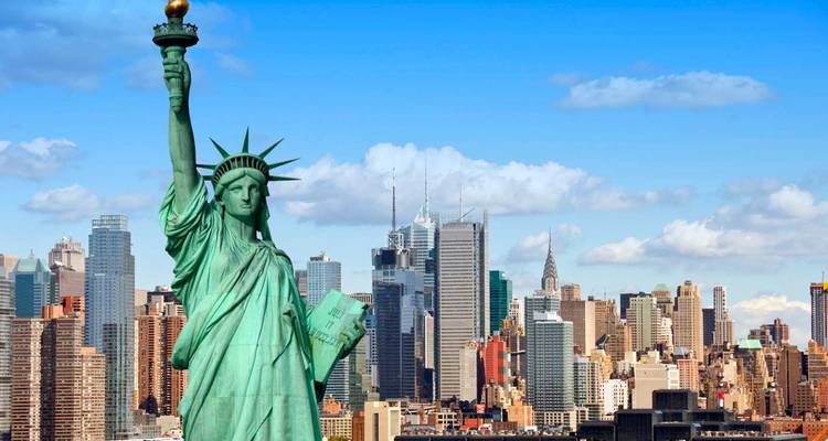 Statue of Liberty standing tall with Manhattan skyscrapers in the background
