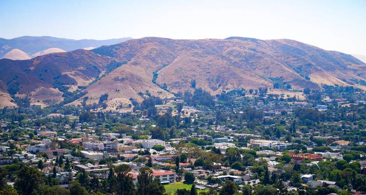 Panoramic view of San Luis Obispo valley with arid hills surrounding the small city below.