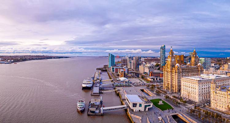 Aerial panorama of Liverpool waterfront with historic Liver Building and docks along the Mersey