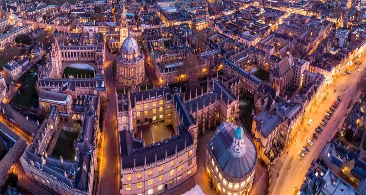 Twilight aerial panorama of Oxford’s historic colleges and glowing streets