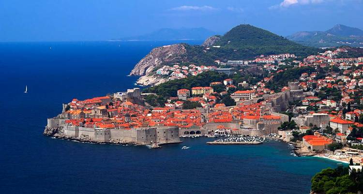 Stunning aerial of Dubrovnik’s walled old town jutting into the deep blue Adriatic Sea.