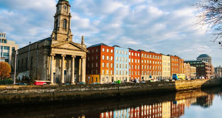 Riverside Georgian streetscape and church in Cork illuminated by late afternoon light.