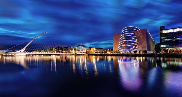 Nighttime reflections of Dublin’s Samuel Beckett Bridge and Convention Centre in the River Liffey.