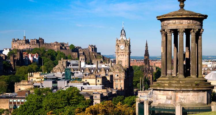 Classic panorama of Edinburgh from Calton Hill with Dugald Stewart Monument, Balmoral clock tower and Edinburgh Castle dominating the skyline.