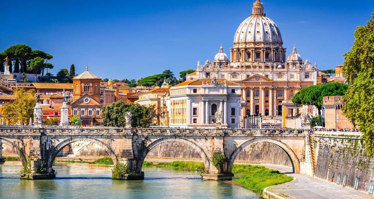 Iconic St. Peter's Basilica dome and Ponte Sant'Angelo over the Tiber River on a bright day