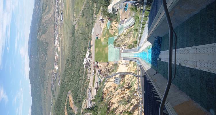 View looking down an Olympic ski jump ramp toward the valley and mountains at Park City.
