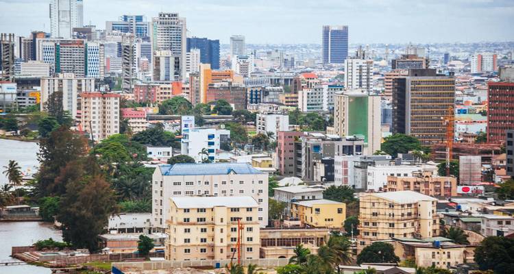 Skyline of Lagos with high-rise buildings, lagoons and palm trees.